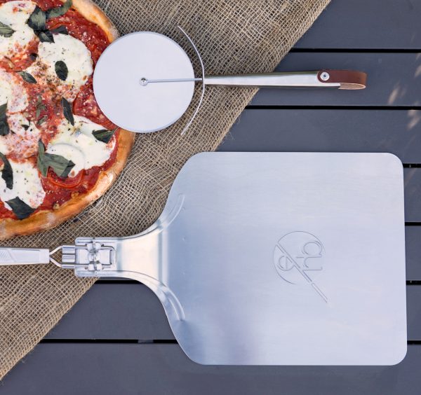 Pizza peel and pizza cutter with pizza
